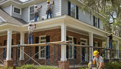 Shreveport, LA siding contractor installing durable vinyl siding on a residential home